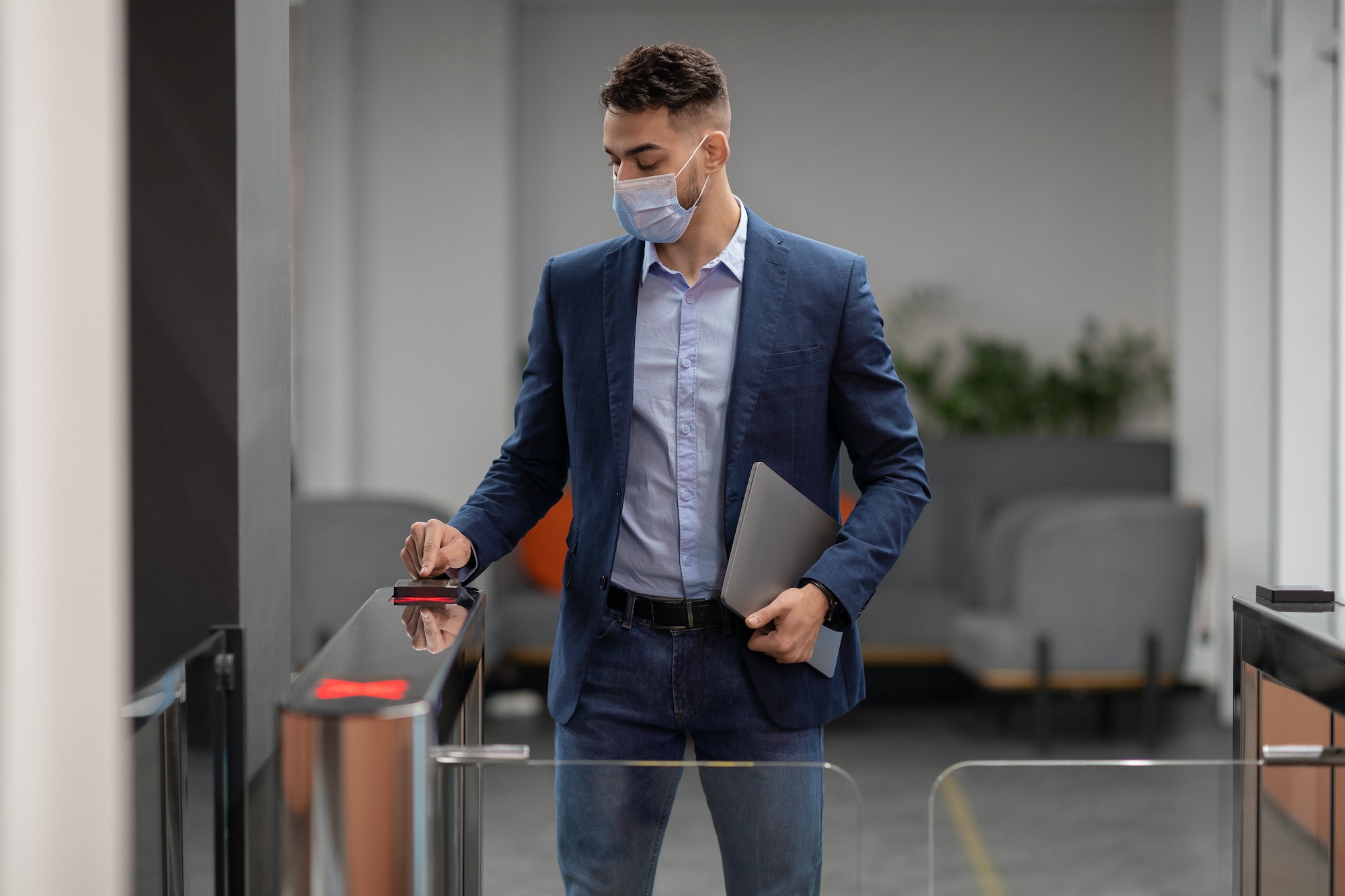Arab guy in face mask employee entering security code